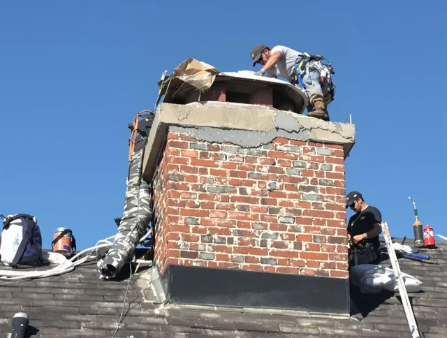 Palm Beach Gardens Chimney Sweep installing a custom chimney crown in Palm Beach Gardens, FL