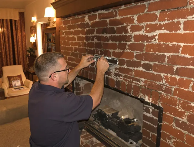 Palm Beach Gardens Chimney Sweep expert fixing a fireplace in Palm Beach Gardens, FL
